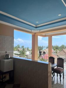a dining room with a view of a balcony at Stardust Villa - ** Hotel in Paje