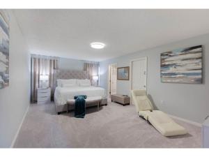 a large bedroom with a bed and a chair at Best place to unwind and have lots of fun! in Kissimmee
