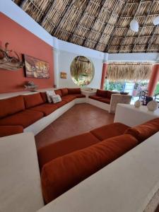 a living room with a large couch and a table at Casa Gaviota in San José de Guatemala