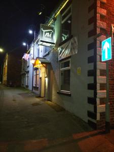 a street sign in front of a building at night at THE NEW INN Newton Derbyshire in Tibshelf