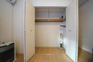 a walk in closet with a glass door at Residence Hotel Liberte in Sapporo