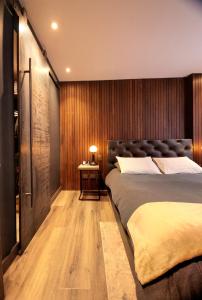 a bedroom with a large bed and a table at Morph Chicó in Bogotá