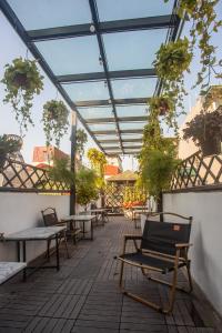 een patio met tafels, banken en potplanten bij Lanha Hotel - Homestay in Hanoi