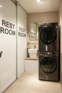 a bathroom with a washer and dryer in a room at Lanha Hotel - Homestay in Hanoi