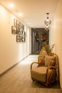 a hallway with a chair and pictures on the wall at Lanha Hotel - Homestay in Hanoi