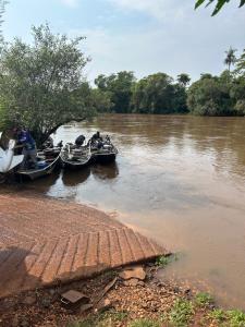 a group of people in boats on a river at Casa junto a natureza in Dourados