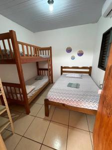 a small room with two bunk beds in it at Casa junto a natureza in Dourados