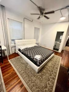 a bedroom with a bed and a ceiling fan at Legacy - Spring Garden University City in Philadelphia