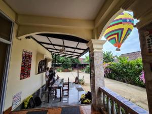 a porch with a kite hanging from a building at Saphaothong guesthouse in Vang Vieng