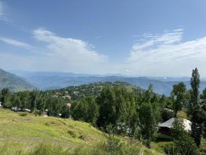 a view of a hill with mountains in the background at Entire Apartment 2bed Condo at Burban Oakwood in Bhurban