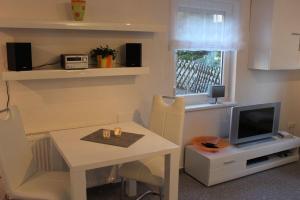 a living room with a table and a television at Ferienwohnung Arlt in Bad Harzburg