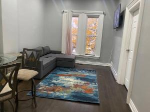 a living room with a couch and a window at Downtown apartment 2/3 people . in Bowmanville