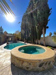 a large swimming pool with a stone circle around it at Charming 6BR Family Home with Private Pool -ENC-UC in Los Angeles
