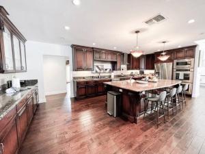 a large kitchen with a large island in the middle at Charming 6BR Family Home with Private Pool -ENC-UC in Los Angeles