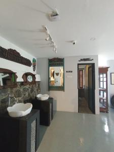 a bathroom with two sinks and two mirrors at The Culture Hotel And Gallery in Bogor
