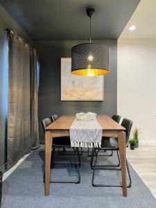 a dining room with a wooden table and a lamp at Spacious 2BR near Hollywood - BR3 in Los Angeles