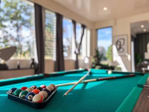 a pool table with billiard balls and cues on it at 3BR Stylish Residence in Los Angeles - OL in Los Angeles