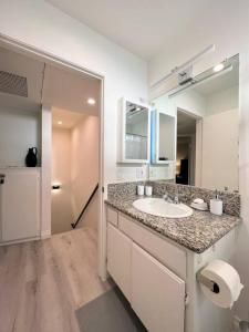 a bathroom with a sink and a large mirror at Spacious 2BR near Hollywood - BR3 in Los Angeles