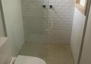 a bathroom with a shower with a toilet in it at Suíte Premium in Itajaí