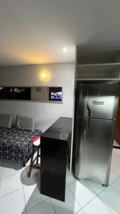 a kitchen with a refrigerator and a bed in a room at Europa Vista Mar in João Pessoa