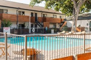 a swimming pool in front of a house at 5 min to DT ~ 2bed 2Bath ~5 star Location in Austin