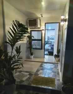 a hallway with potted plants in a house at Parayno's Residence in Manila