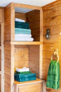 a wooden cabin with towels on a shelf at Cozy Cabin Getaway on Buffalo River with HUGE Patio in Lobelville
