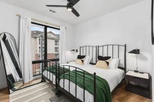 a bedroom with a bed and a large window at Premium Condo with Huge Patio near Vanderbilt & Downtown in Nashville