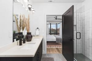a bathroom with two sinks and a mirror at Premium Condo with Huge Patio near Vanderbilt & Downtown in Nashville +35 photos
