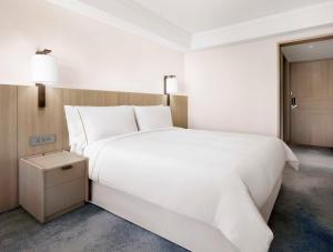 Postel nebo postele na pokoji v ubytování The Westin Josun Busan
