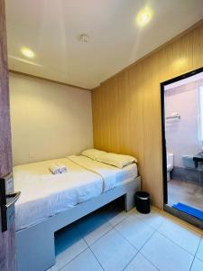 a small bedroom with a bed and a bathroom at Memory Boutique Hotel in Semporna