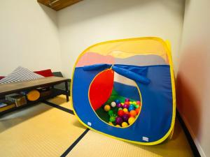 una maleta llena de bolas en una habitación en Pyrenees Cottage - Vacation STAY 24861v en Hakuba