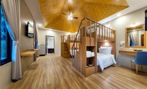 a room with a bunk bed and a staircase at At Rice Resort in Nakhon Nayok
