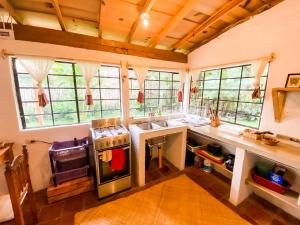 a kitchen with a sink and a stove at Unicorn Reborn - Peaceful Rentals in San Marcos La Laguna