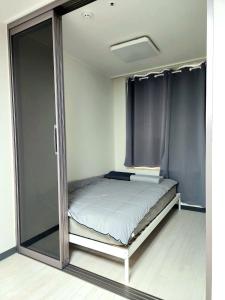 a bedroom with a bed with sliding glass doors at Apartment near Ilsan Dongkuk University Hospital in Goyang