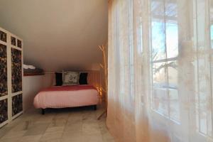 a bedroom with a bed and a large window at La terraza de Algeciras. in Algeciras