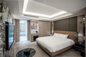 a bedroom with a large bed and a television at 南兜漫旅 in Tainan