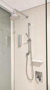 a shower with a shower head in a bathroom at Comfy King The Straits Suite 715 by Elefen Homestay in Melaka +13 photos