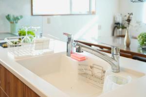 a kitchen sink with a faucet in a kitchen at Canal Villa Otaru in Otaru