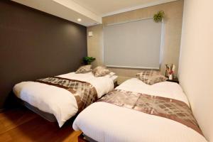 Ένα ή περισσότερα κρεβάτια σε δωμάτιο στο Canal Villa Otaru