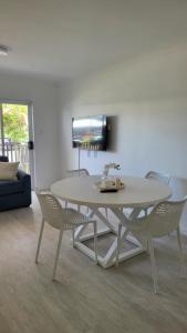 a white table and chairs in a living room at Husky 19 Beautifully Appointed Apartments - GREAT LOCATION - in the heart of Husky in Huskisson