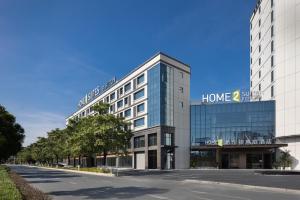 a large building with a home sign on it at Home2 Suites by Hilton Guangzhou Baiyun Airport West in Huadu