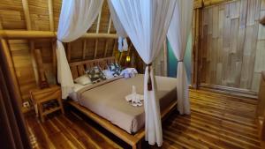 a bedroom with a bed with a canopy at Sekumpul Bali Hidden Space in Singaraja