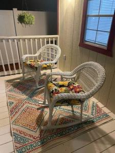 two wicker chairs sitting on top of a rug at The Tiny Cottage in the Springs/ Central FL in Orlando