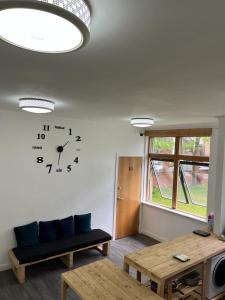 a living room with a clock on the wall at City Centre 3 in Manchester