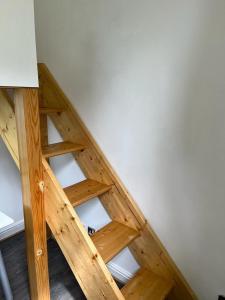 an attic with a wooden staircase in a room at City Centre 3 in Manchester