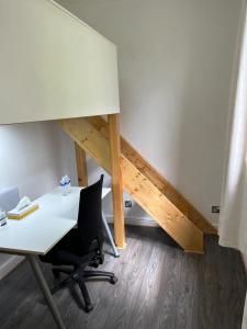 an office with a desk and a chair and a staircase at City Centre 3 in Manchester