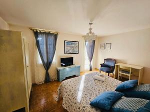 a bedroom with a bed and a chair and a television at La Fabbrica Delle Idee B&B in Fonte