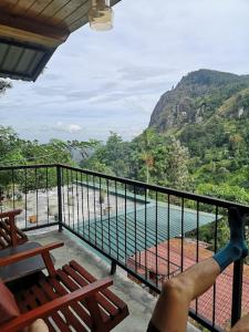 a balcony with a view of a river and mountains at Country Homes in Ella