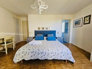 a bedroom with a large bed with blue pillows at La Fabbrica Delle Idee B&B in Fonte